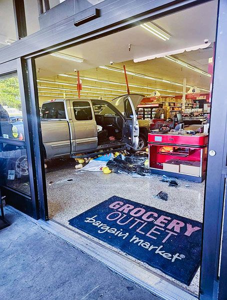 Submitted photo##A vehicle rests in the middle of the checkout area after last week’s crash at Grocery Outlet on Highway 99W in McMinnville. A cashier received minor injuries; no one else was hurt.