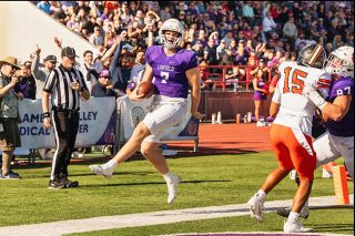 Rusty Rae/News-Register##Linfield quarterback Luke McNabb celebrates a second-quarter touchdown after rushing the ball into the endzone from four yards out. The play gave the Wildcats their first lead of the game at 20-14 lead, which was then followed by 27 unanswered points, much to the delight of the homecoming crowd.