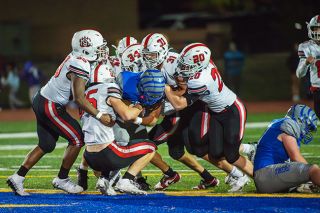 Rusty Rae/News-Register##A swarm of Grizzly defenders take down the ball carrier. After a slow start, McMinnville’s defense played well, allowing just three points in the second half.