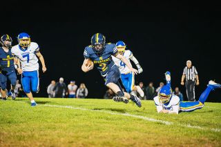 Rachel Thompson/News-Register##Alex Martison keeps the run going after a Vernonia/Jewell defender attempted to trip him up from behind.