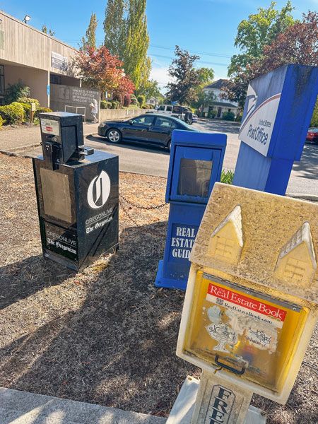 Kirby Neumann-Rea/News-Register##Dust-covered publication boxes stand somewhat forlorn in front of the McMinnville Post Office.