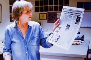 Submitted photo##Laurie Ezzell Brown holds a page from her family-owned newspaper, The Canadian Record. Brown is featured in the documentary “For The Record,” screening Oct. 23 at Linfield.