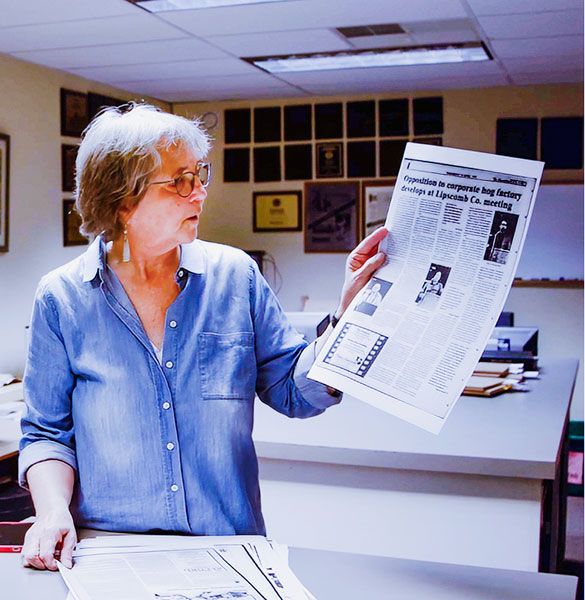 Submitted photo##Laurie Ezzell Brown holds a page from her family-owned newspaper, The Canadian Record. Brown is featured in the documentary “For The Record,” screening Oct. 23 at Linfield.