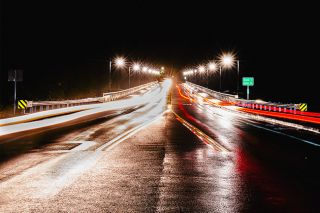 Rusty Rae/News-Register##Ribbons of car lights stretch the length of Three Mile Lane Bridge Sunday night in this extended exposure looking southeast. ODOT and city officials dedicated the new span, completed this summer and featuring wider vehicle lanes and pedestrian access on both sides.