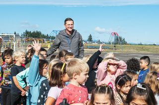 Rusty Rae/News-Register##McMinnville School Board Chairman Jason Bizon greets Grandhaven first-graders as they prepare to visit a “pumpkin patch.” Bizon said he likes to spend time at schools to see what students are doing and to show support for teachers and other educators. Events such as the pumpkin patch also are examples of the many community partnerships that support education in the McMinnville district, he said.