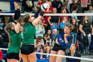 Rachel Thompson/News-Register##Amity senior Saralynn Grove gets up at the net for a kill against Rainier.