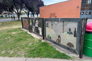 Kirby Neumann-Rea/News-Register##McMinnville High School fabrication students cut and welded three panels to make a mural on display at 15th and Evans, the southwest corner of the school. The design features McMinnville icons, including an alien and a Grizzly.