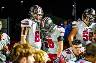 Submitted by Amy Webster##Dayton junior Logan Oliveira, left, and senior Corbin Sanchez lean on each another during the team’s post-game talk after their upset bid to No. 1 Suislaw fell just short.