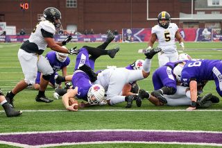 Rusty Rae/News-Register##Linfield quarterback Luke McNabb dives across the goal line during Saturday’s game with Pacific Lutheran. Linfield topped the Lutes for the 24th consecutive game, this time 38-10.