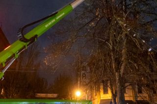 Rusty Rae/News-Register##Crew from Premiere Holiday Lights uses a high lift to string new downtown twinkle lights Wednesday night at Third and Davis streets. Installation started the night of Nov. 11, and progresses east toward Johnson Street.