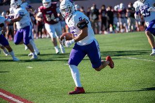 Rusty Rae/News-Register file photo##Linfield Linebacker Blaze Holani after an interception earlier this season. On Saturday, the junior from Hawaii intercepted a Whitworth pass and raced for a 62-yard defensive score that put the Wildcats up 31-7.