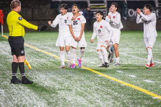 Rusty Rae/News-Register  ##Sebastian Lopez (26) hollers towards the Mac fans after his goal just before halftime put the Grizzlies up 2-0 in last Saturday’s state championship game. Celebrating with him are Nicholas Lozano (8), Abraham Cuevas George (13) and Bryant Orozco (14).