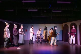 Rachel Thompson/News-Register##In Amity High School’s production of “Beowulf (and the Bard),” the Bard (Zane Aldrich), second from right, chronicles the quest of Beowulf (Noah Milldrum), far right. From left, the photo also shows villagers Colton Maxwell, Izabella Swendig and Ainsley Walker along with Unferth (Kiah Hernandez), Gunborg (Joleen Benuche), Hrothgar (Liliana Vera) and Aeschere (Danica Weaver).