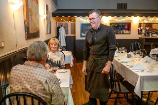 Rusty Rae/News-Register##Chef Gilbert Henry talks with diners at Cuvée, which marked 20 years in Carlton in 2024. He prepares French dishes his way, with influences from other cultures, such as Tahiti, where he served in the French military, or islands where he worked for Club Med. Henry’s passions for food and music — he plays saxophone — date back to his childhood in the Alsace region of France.