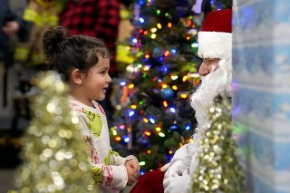 Rachel Thompson/News-Register##During the Amity tree lighting event Friday, Dec. 6, Bodhi Ulloa of Amity tells Santa his wishes. In addition to the Christmas season, Bodhi was celebrating his third birthday that day. He visited Santa after watching the Christmas parade and tree lighting.