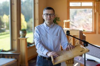 Rusty Rae/News-Register##Alex Kachkovskyi, who grew up in Ukraine, stands in the chapel at Rock of Ages Retirement Village. As chaplain at the McMinnville facility, he said he enjoys meeting and working with residents, and helping them with their spiritual needs.