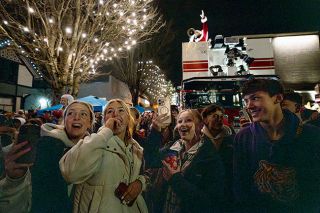 Rachel Thompson/News-Register##Mac High students Alex Bates, left, Rylan Carton, Rylie McManus and Rhyder Darnell celebrate the illumination of the McMinnville Christmas tree on Nov. 29.