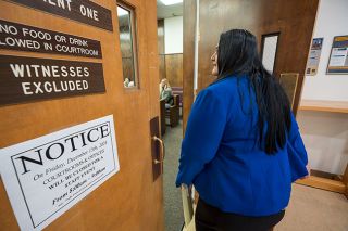 Rachel Thompson/News-Register##Office Administrator and Director of Crime Victim Services Cecilia Martinez enters courtroom 241, where she will sit with the victim and family members during a jury trial. Martinez and other advocates with CVS will attend court proceeding with or on behalf of victims. If a victim cannot attend court, advocates keep victims informed of court proceedings with a phone call.