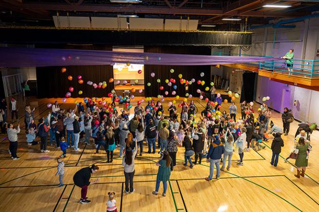 Rusty Rae/News-Register##Families shout “Happy Noon Year!” after counting down the seconds to 12 p.m. Dec. 31 in the McMinnville Community Center gym. Balloons drifted down from the ceiling to mark the arrival of 2025 – almost.