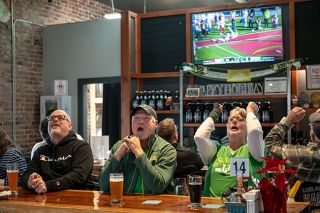 Rusty Rae/News-Register##Oregon fans Peter Bradley, left, Steve McGibbon and Carrie Sgheiza are overcome with emotion at Two Dogs Taphouse as Ohio State scores another touchdown on New Year’s Day at the Rose Bowl.