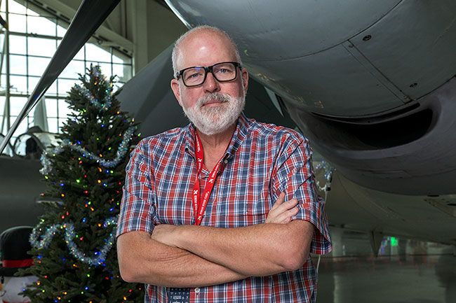 Rusty Rae/News-Register##Evergreen museum CEO Scot Laney stands with his favorite plane, a Skyraider used in the Korean and Vietnam wars. Laney, named CEO in August, wants everyone in Yamhill County to come to the museum to see the rare and historic aircraft and space vehicles.