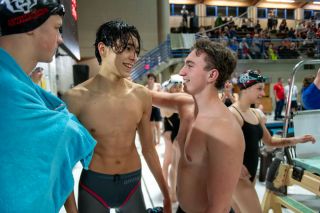 Rusty Rae/News-Register##Ethan Krigbaum, right, congratulates Ko Depweg after the junior broke the school record in the 100-yard breaststroke on Thursday, Dec. 19 in a dual meet at home against Sherwood.