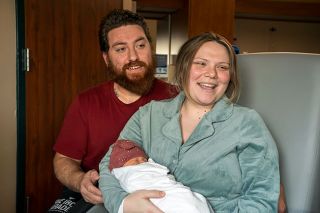 Rachel Thompson/News-Register##New parents Hailey Smith and Jose Coria cuddle their new daughter, Weslie Ray Coria, who was the first baby born in 2025 at Willamette Valley Medical Center. Weslie arrived at 8:25 a.m. Saturday, much to her parents’ delight. They received a basket of stuffed animals and baby items in honor of her status as the first baby of the year.