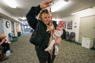 Rachel Thompson/News-Register##In Provoking Hope’s lobby, Aly Winstead of McMinnville holds 3-month-old Sapphire Rose, daughter of a client. “This place saved my life six years ago,” Winstead said. “I could come here and know that my sobriety would be fortified, as long as I stayed for just a couple hours.”