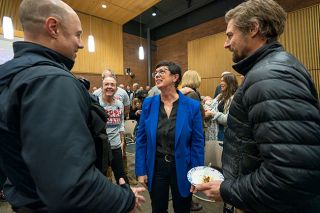 Rachel Thompson/News-Register##Mayor Kim Morris talks with Oregon State Police Trooper Jamison Goetz, left, and resident Chaz Gibbons during a celebration following the swearing-in ceremony. Gibbons ran unsuccessfully for the council seat won by Scott Cunningham.