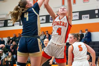 Ossie Bladine/News-Register##Madyson Bell avoids the inside pressure from Banks forward Jordyn Maller to get a shot off. Bell’s 19 points was not enough to help the Tigers get back in the game after falling behind during a disastrous second quarter.