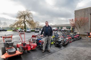 Rusty Rae/News-Register##Alex Botten of Northwest Logging stands where his company’s property meets Ed’s Automotive, in background. The businesses’ shared parking lot uses an easement that would be needed for access to a proposed apartment complex on Stratus Avenue.