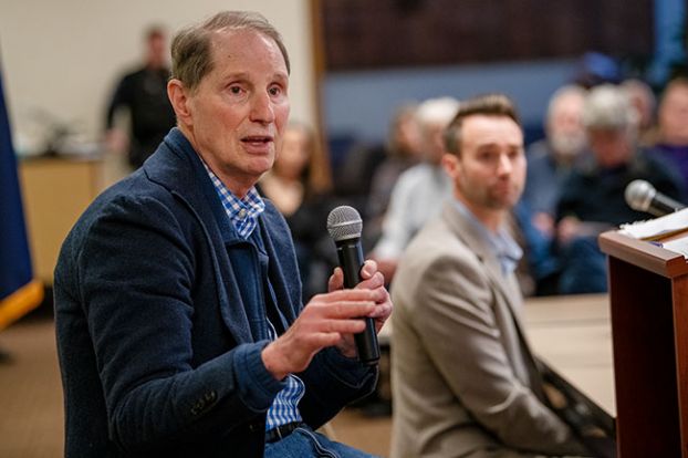 Rusty Rae/News-Register##Sen. Ron Wyden responds to a question during the Q-and-A segment of Saturday’s town hall at Chemeketa Community College campus in McMinnville. Behind him is moderator Russell Jones, dean of general education at the college.