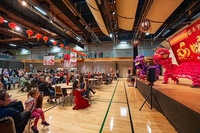 Rachel Thompson/News-Register##On stage, Portland’s International Lion Dance Team opens the Lunar New Year Celebration Sunday at the McMinnville Community Center, a third annual event hosted by the Asian Heritage Association. Lion dancers are chosen to open special events because they are believed to bring good luck and prosperity and drive away evil spirits. The loud drums, cymbals and gongs are believed to help ward off negative energy and welcome a fresh start. The lions’ playful movements symbolize chasing away misfortune and inviting good fortune for the new year.