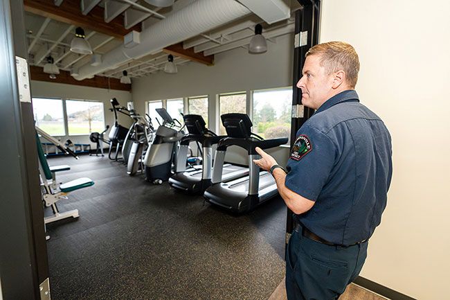 Rachel Thompson/News-Register##Assistant Chief Ty Darby walks into the station’s gym, one of the many amenities of the new station. It can be used by employees during downtime once plans move forward to house emergency operations at the location.