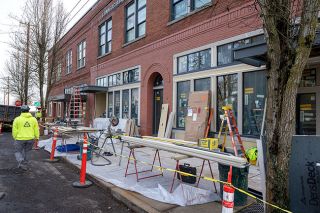 Rachel Thompson/News-Register##Construction workers are installing facade finishings as the renovation of Merchant Block in downtown Dayton nears completion. The 12-unit hotel and four ground floor businesses hope to open by Memorial Day, according to city staff.