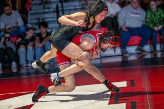 Rusty Rae/News-Register##McMinnville senior Arianna Raya (110, 8-14) takes down her Sherwood opponent on Feb. 6 at a league dual.