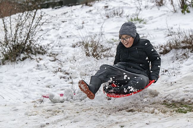 Rusty Rae/News-Register##
Dunaway sixth-grader Brayden Bounyavong get a little air as he flies over a ramp he and others made Friday morning on a hill in McMinnville s Lower City Park.