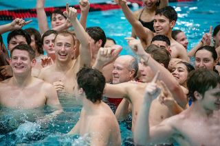 Rachel Thompson/News-Register##McMinnville High School swim coach Jason Hafner is at the center of a splash party after receiving the traditiona dunking in the pool following a Districts meet team title. Hafner, set to retire after this season, is hoping that at the state meet this weekend the boys team can win one last piece of hardware under his watch.