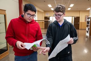 Rusty Rae/News-Register##McMinnville High School juniors Luis Minero, left, and Zayden Walter look over their stock portfolios from their consumer finance class. They had $5,000 of pretend money to invest, and both saw their stocks double during the first semester – Luis bought shares in a rocket company, and Zayden invested in Tesla. Along with Jason Pineda, they were the top three investors in the class.