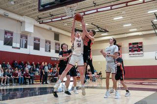 Rachel Thompson/News-Register##Dayton senior Clyde Rosenberg (51) powers  by Scio’s Brycen Zosel and Haydin Tibbs for a rebound. Rosenberg finished with 33-points.