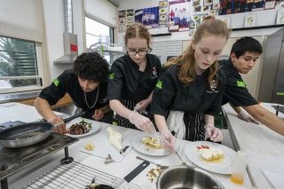 Rachel Thompson/News-Register##Ivan Duarte, Sydney Hall, Grace Goularte and Erick Chinchilla hurry to put the finishing touches on their plates during a practice for the ProStart competition. The 11th-graders will represent Dayton High School Monday.