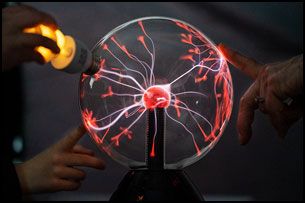 Rachel Thompson/News-Register##Plasma ball entertains and educates at Saturday’s Science Fest, hosted by Carlton Observatory at Evergreen Aviation Museum. Participants placed lightbulbs,  foil, coins, and other conductors against the glass, filled with gases and a high-voltage electrode. This affects the current’s flow through filament, creating colorful tendrils of light.