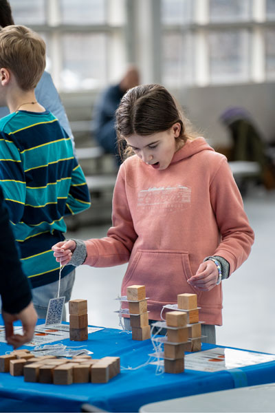 Rachel Thompson/News-Register##Grace Morrison, age 11, of Salem, reacts as she learns about inertia, Newton’s First Law, at Saturday’s Science Fest at Evergreen.