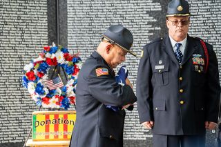 News-Register file photo##After the Honor Guard folded the flag, Angel Mendoza, left, United Veterans Honor Guard Commander, pauses in reflection of the service and sacrifice of veterans during the opening ceremony for the Oregon Memorial Traveling Wall, Friday, March 28, 2025, at Evergreen Aviation & Space Museum. At right is Honor Guard member Staff Sergeant Bobb Fleming.