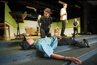 Rachel Thompson/News-Register##Erica (Desirae Weaver) kneels over the body of Inspector Fuller (Joel Sims) in “Murder Mystery at the Murder Mystery,” which will play April 18-19 and 24-26 at Amity High School. Richard (Hezekiah Hernandez), standing, questions what’s going on in the mixed-up comedy. Rachel Thompson/News-Register##Erica (Desirae Weaver) kneels over the body of Inspector Fuller (Joel Sims) in “Murder Mystery at the Murder Mystery,” which will play April 18-19 and 24-26 at Amity High School. Richard (Hezekiah Hernandez), standing, questions what’s going on in the mixed-up comedy.
