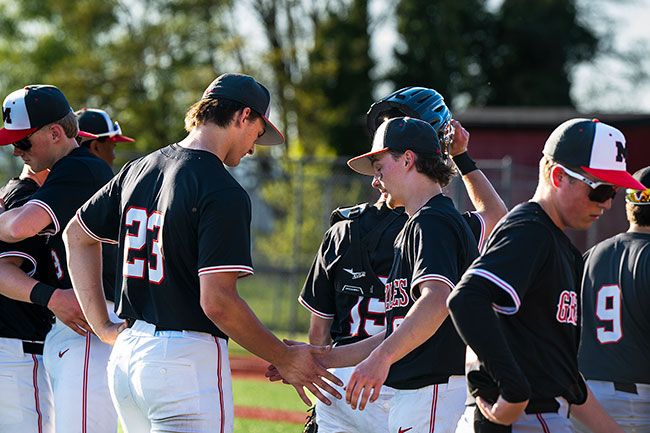 Rusty Rae/News-Register##Carnaham, 23, and Tyler Brummit give one another a celebratory low five after McMinnville won the rubber match against Newberg, 3-1. Rusty Rae/News-Register##Carnaham, 23, and Tyler Brummit give one another a celebratory low five after McMinnville won the rubber match against Newberg, 3-1.