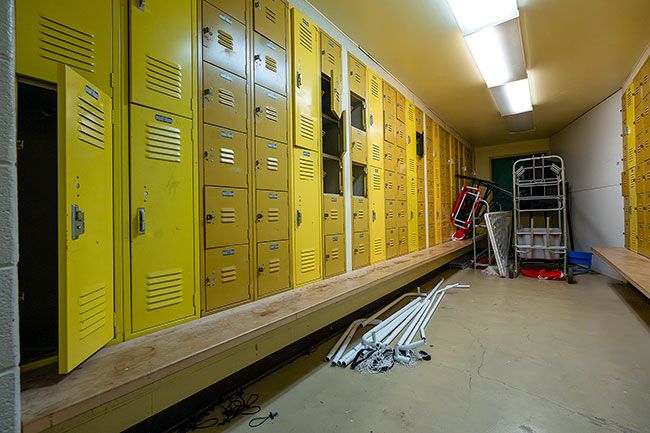 Rachel Thompson/News-Register## The girls&rsquo; locker room at the old Faulconer Chapman School detached gym is boarded off and used for additional district storage. Many of the lockers are in disarray with doors and hardware removed or damaged.