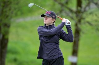 Rusty Rae/News-Register##Sophomore Mabel Findley follows her ball after a shot with a fairway wood on Monday at Chehalem Glenn Golf Course. Findley shot a career-best 73, 1-over-par, on the day to maintain the lowest average score in the Pacific Conference this season.