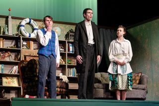 Rachel Thompson/News-Register##From left, Joel Ruden, Campbell Willis and Brooke Anderson perform a scene from “Fools” at McMinnville High School. Ruden, as Leon Tolchinsky, begins to grasp the mysterious curse plaguing the town, while Willis and Anderson, playing Dr. and Lenya Zubritsky, explain its peculiar effects on the villagers, including their daughter, Sophia.
