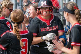 Rusty Rae/News-Register##Ariel Glynn is all smiles after her second-inning home run to get McMinnville on the board.